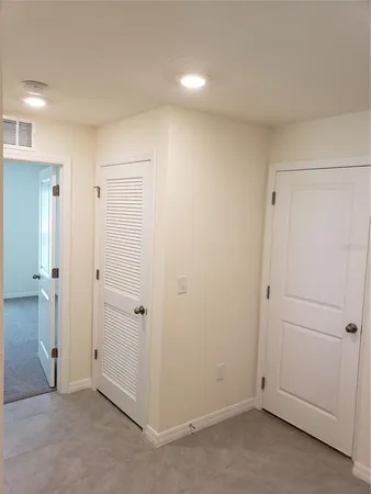 an empty room with closet area