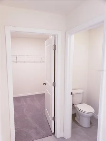 a white toilet sitting next to a bathroom sink