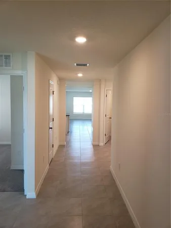 a view of a hallway with wooden shelves