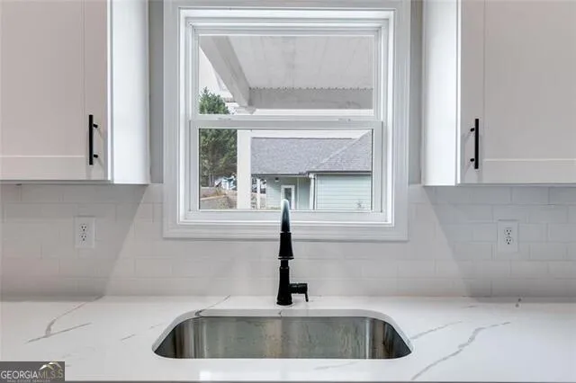 a kitchen with a sink and cabinets