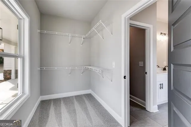 a view of walk in closet with empty racks