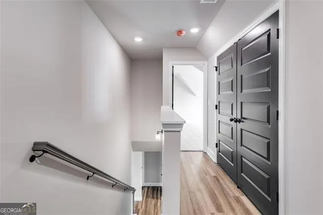 a view of a hallway with wooden floor