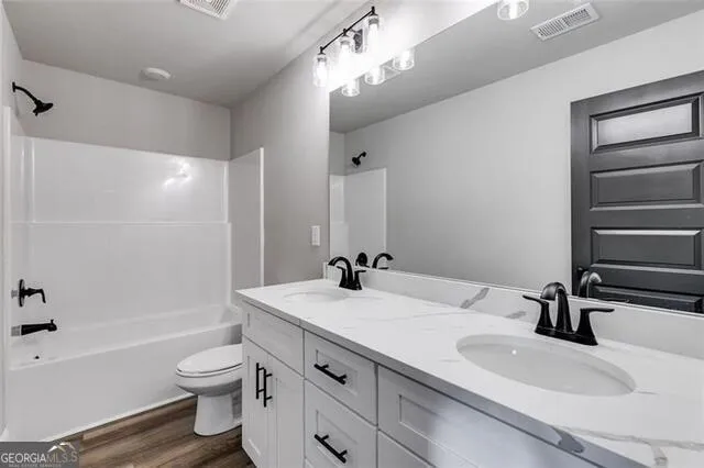 a bathroom with a sink a toilet and a bathtub