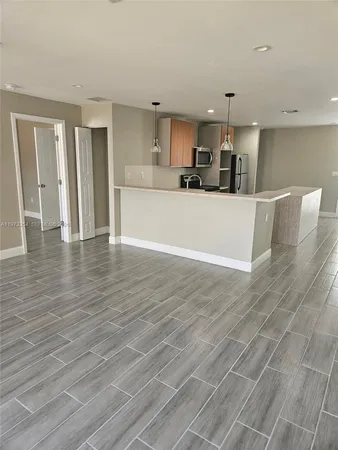 a view of kitchen with cabinets and wooden floor