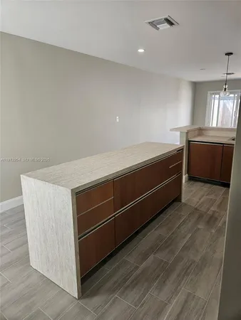 a view of room with window and wooden floor