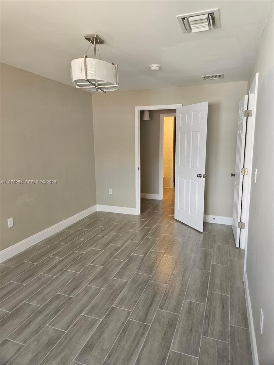 3906 Northwest 207 St Road, Unit 3906 Miami Gardens, FL 33055 - Photo 17 of 26 a view of empty room with wooden floor