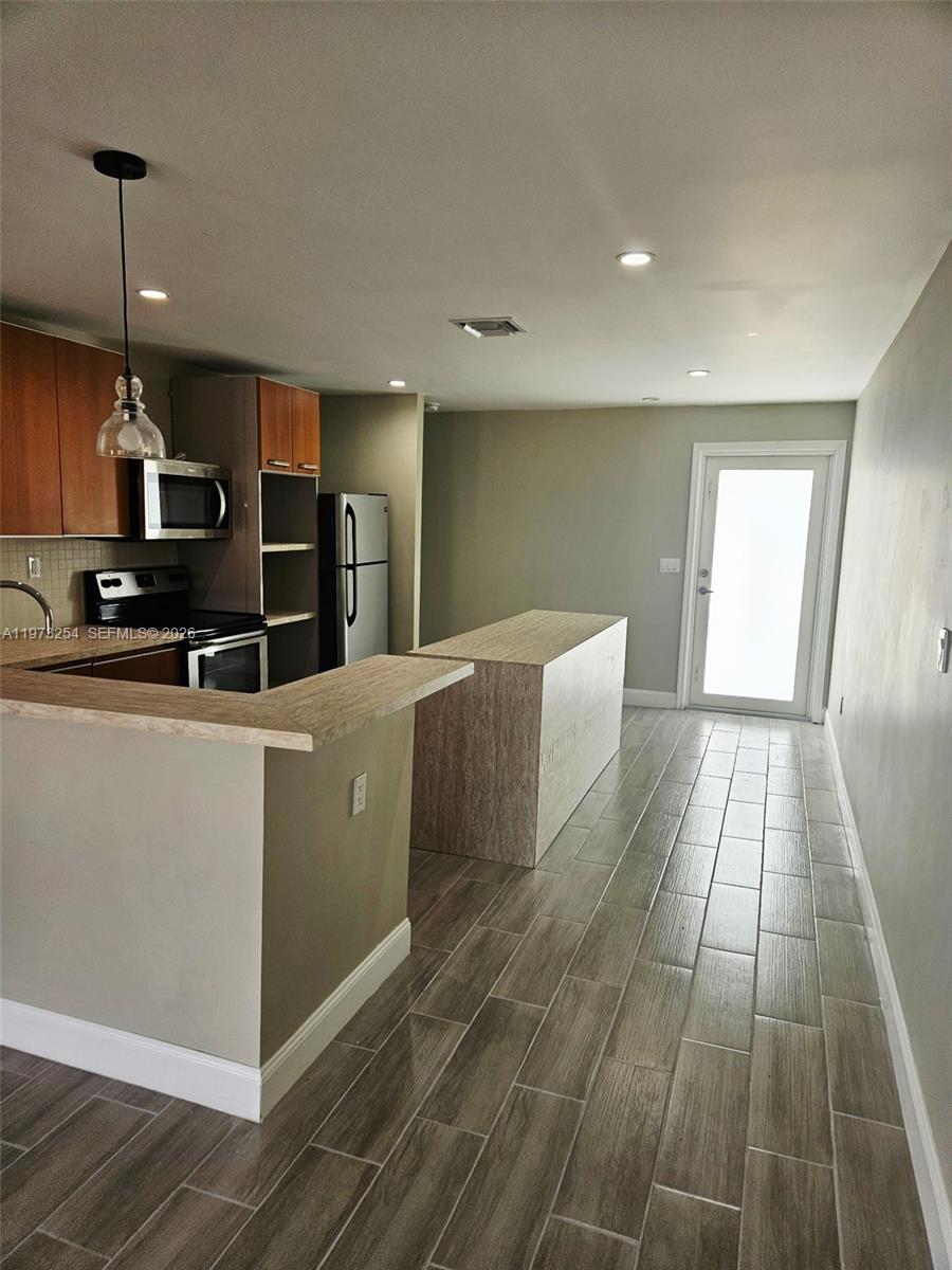 3906 Northwest 207 St Road, Unit 3906 Miami Gardens, FL 33055 - Photo 20 of 26 a kitchen with stainless steel appliances a refrigerator sink and microwave