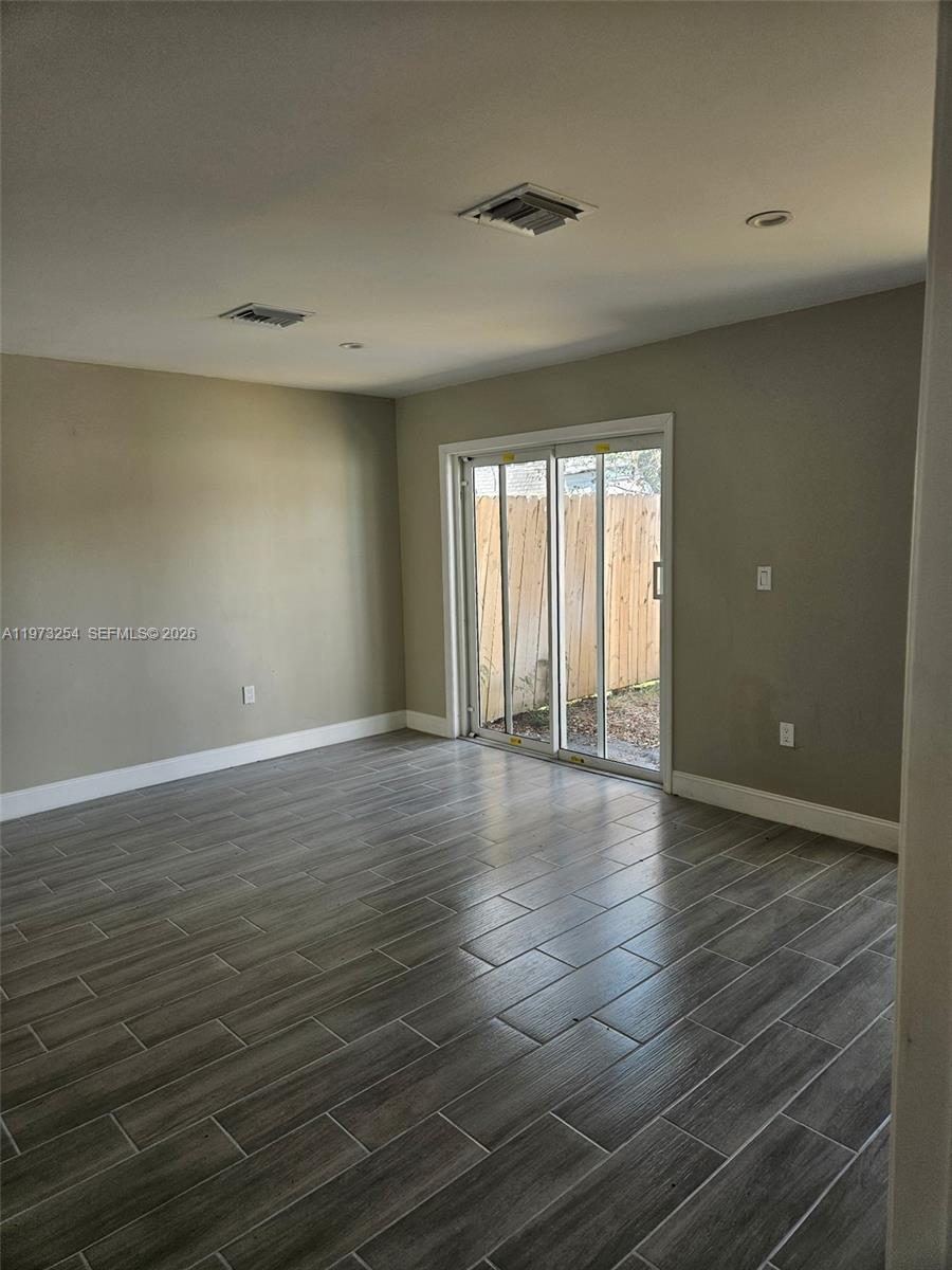 3906 Northwest 207 St Road, Unit 3906 Miami Gardens, FL 33055 - Photo 22 of 26 wooden floor in an empty room with a window