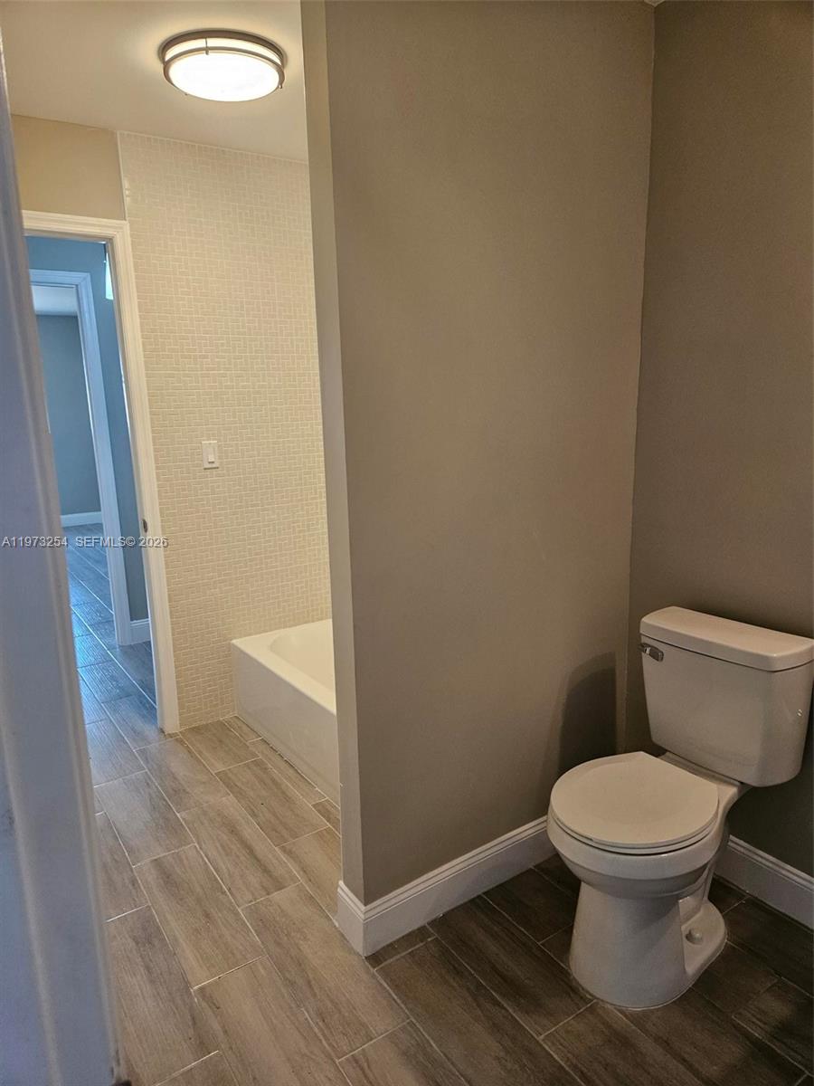 3906 Northwest 207 St Road, Unit 3906 Miami Gardens, FL 33055 - Photo 26 of 26 a white toilet sitting next to a shower