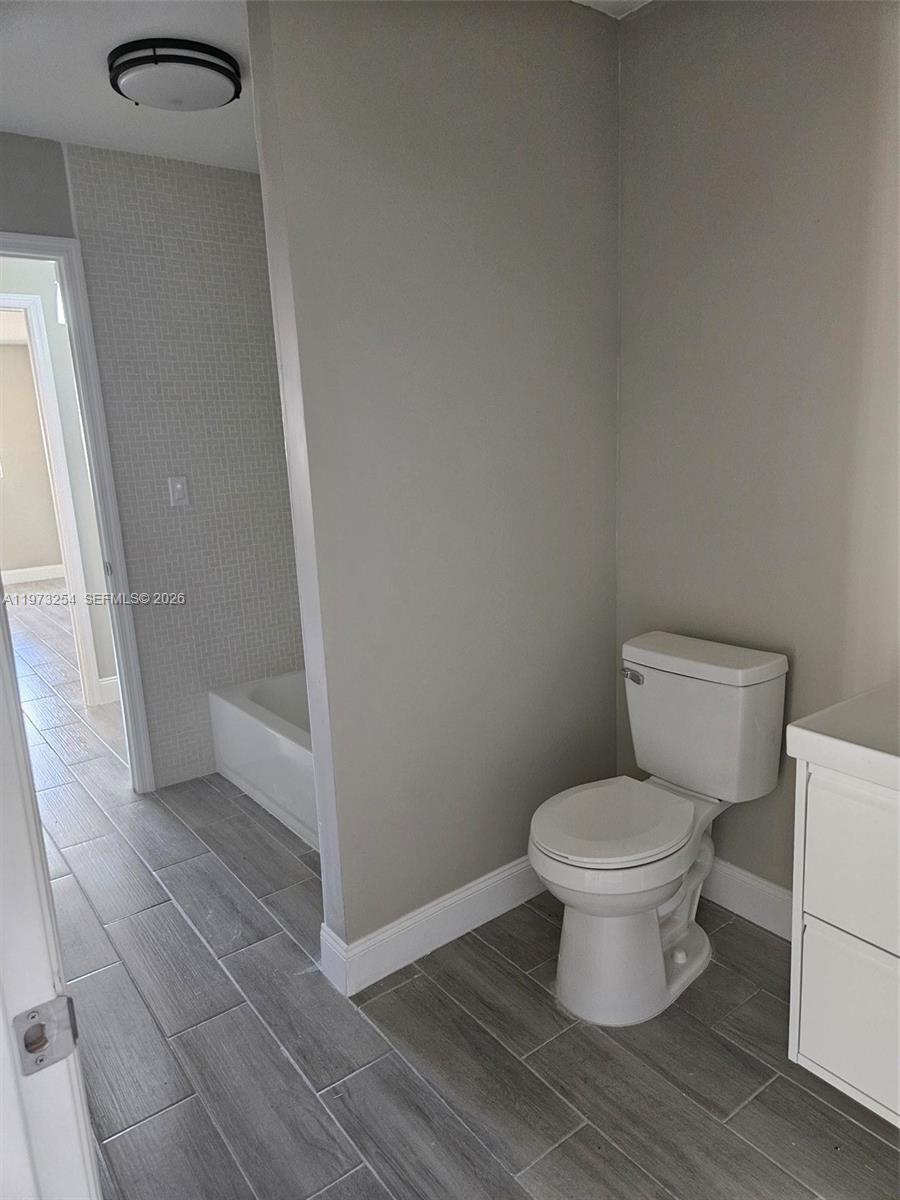 3906 Northwest 207 St Road, Unit 3906 Miami Gardens, FL 33055 - Photo 4 of 26 a white toilet sitting next to a sink