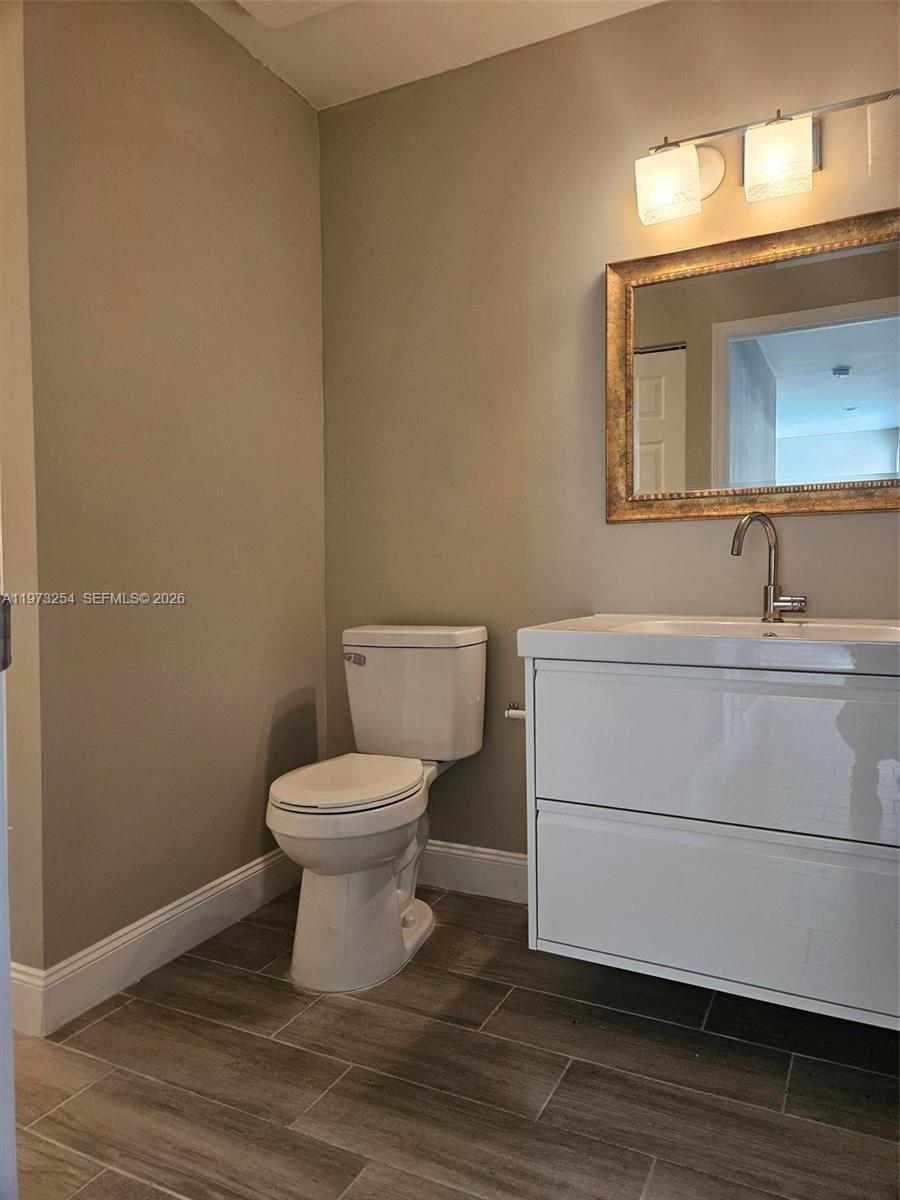 3906 Northwest 207 St Road, Unit 3906 Miami Gardens, FL 33055 - Photo 6 of 26 a bathroom with a toilet sink and mirror
