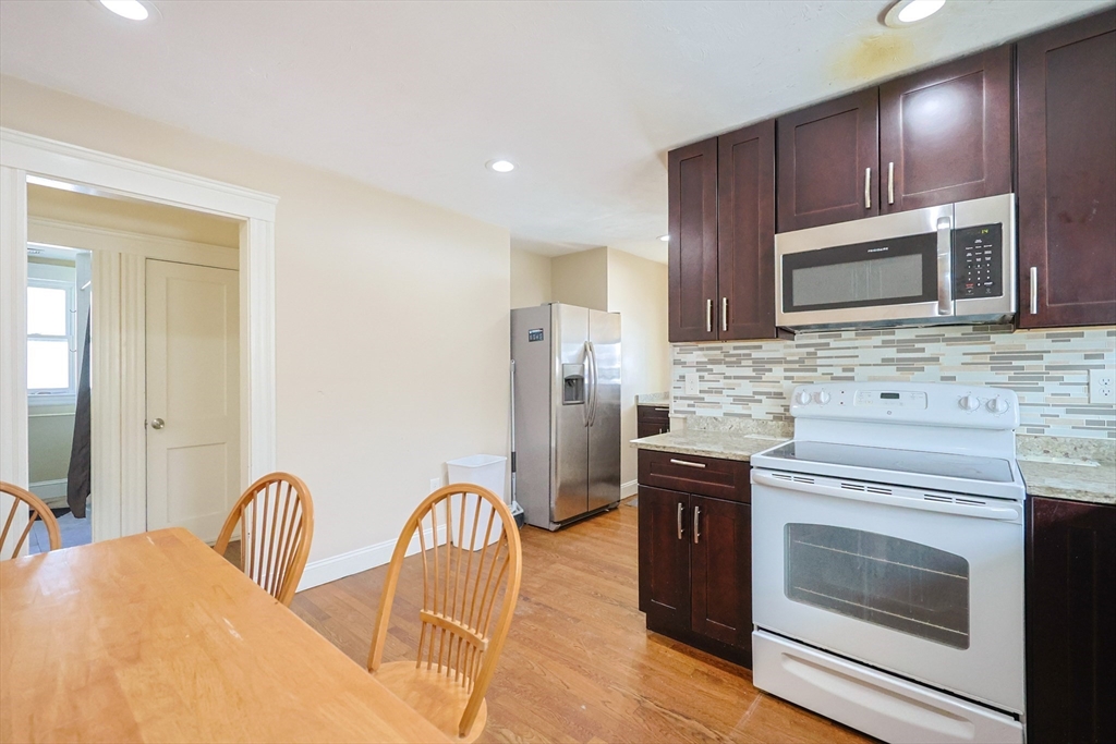 96 Mansfield Street Framingham, MA 01702 - Photo 11 of 39 a kitchen with stainless steel appliances granite countertop a stove microwave and refrigerator
