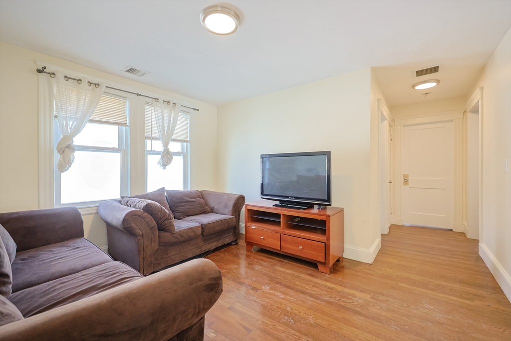 96 Mansfield Street Framingham, MA 01702 - Photo 14 of 39 a living room with furniture and a flat screen tv