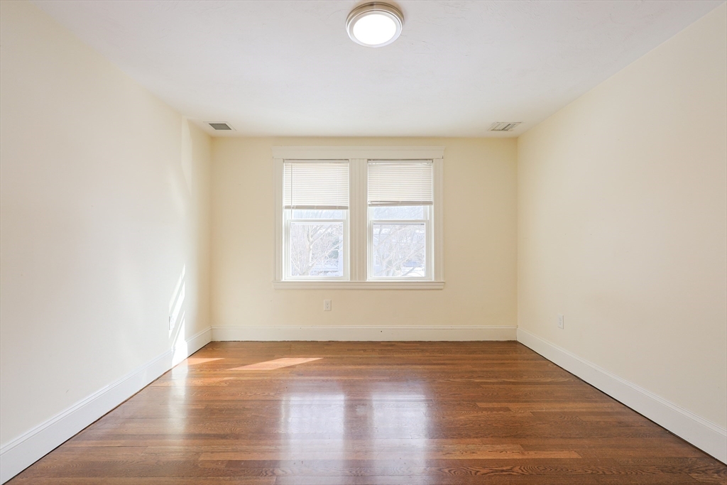 96 Mansfield Street Framingham, MA 01702 - Photo 16 of 39 an empty room with wooden floor and windows