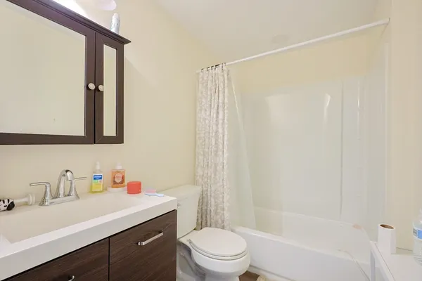 a bathroom with a sink vanity mirror and toilet