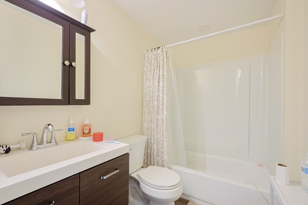 96 Mansfield Street Framingham, MA 01702 - Photo 20 of 39 a bathroom with a sink vanity mirror and toilet