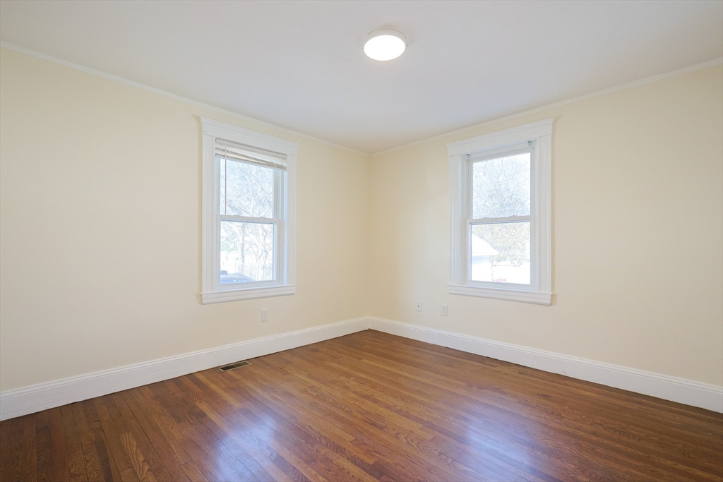 96 Mansfield Street Framingham, MA 01702 - Photo 21 of 39 an empty room with wooden floor and windows
