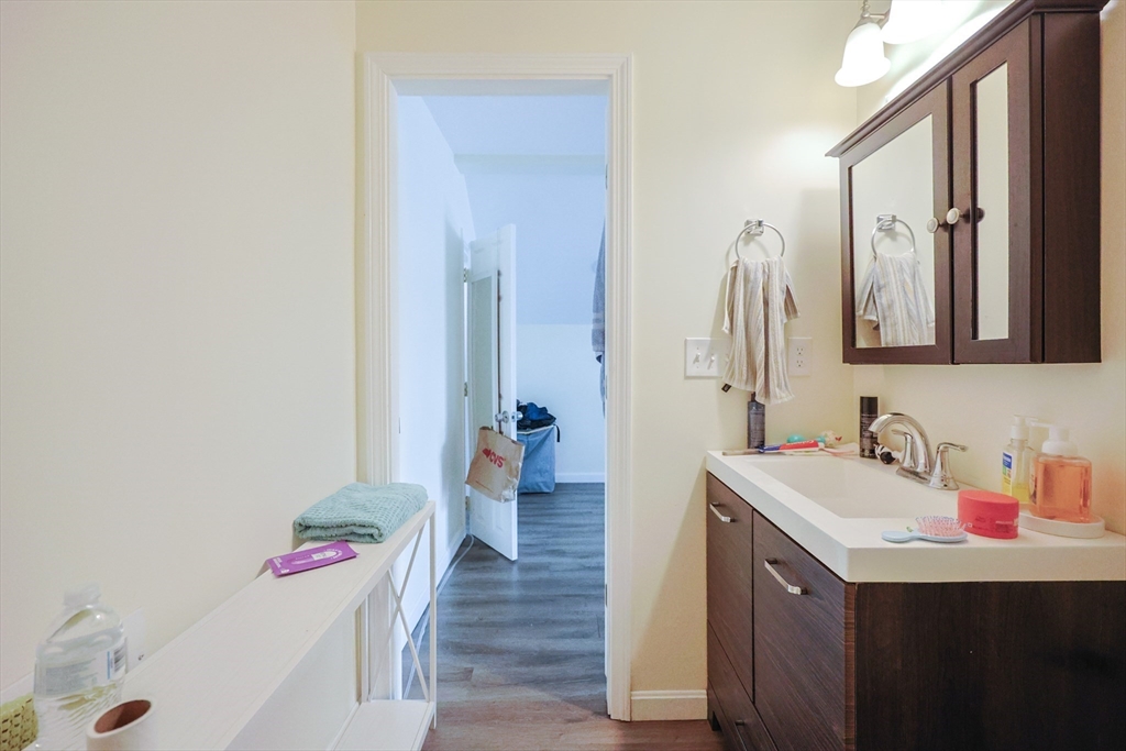 96 Mansfield Street Framingham, MA 01702 - Photo 25 of 39 a bathroom with a sink vanity and a mirror