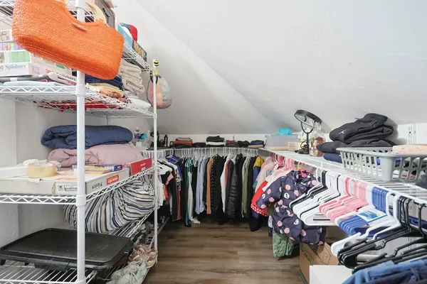 a view of walk in closet with clothes