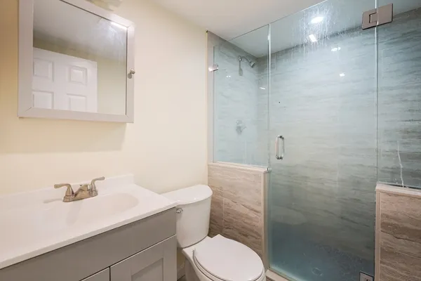 a bathroom with a sink toilet and shower