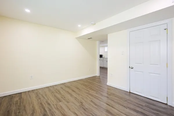 a view of an empty room with wooden floor
