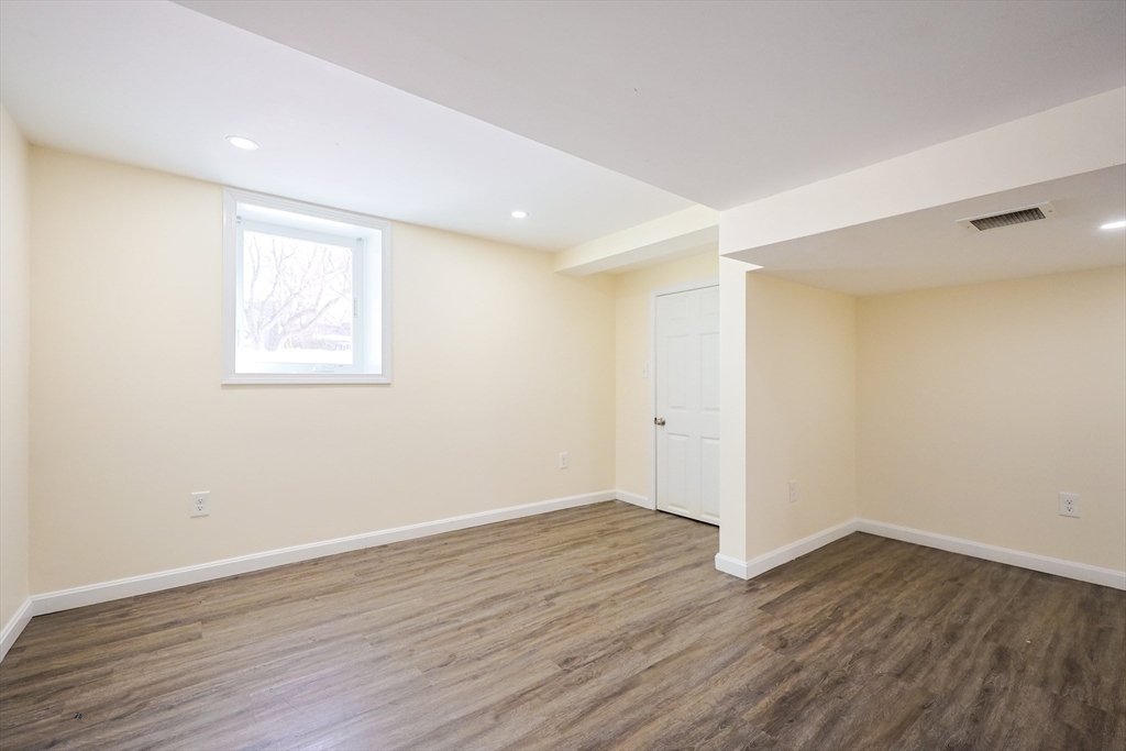 96 Mansfield Street Framingham, MA 01702 - Photo 33 of 39 a view of an empty room with wooden floor and a window