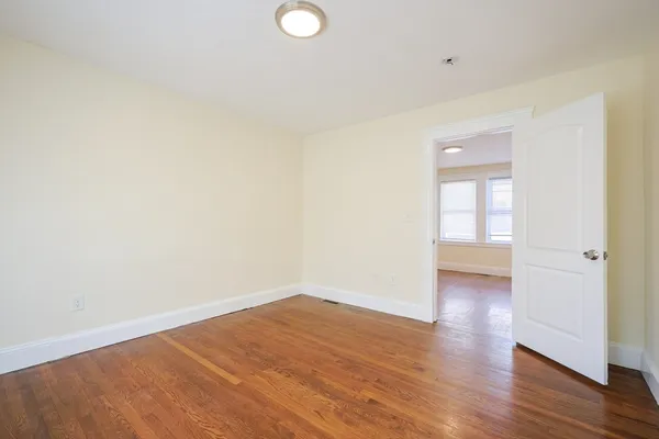 a view of an empty room and wooden floor