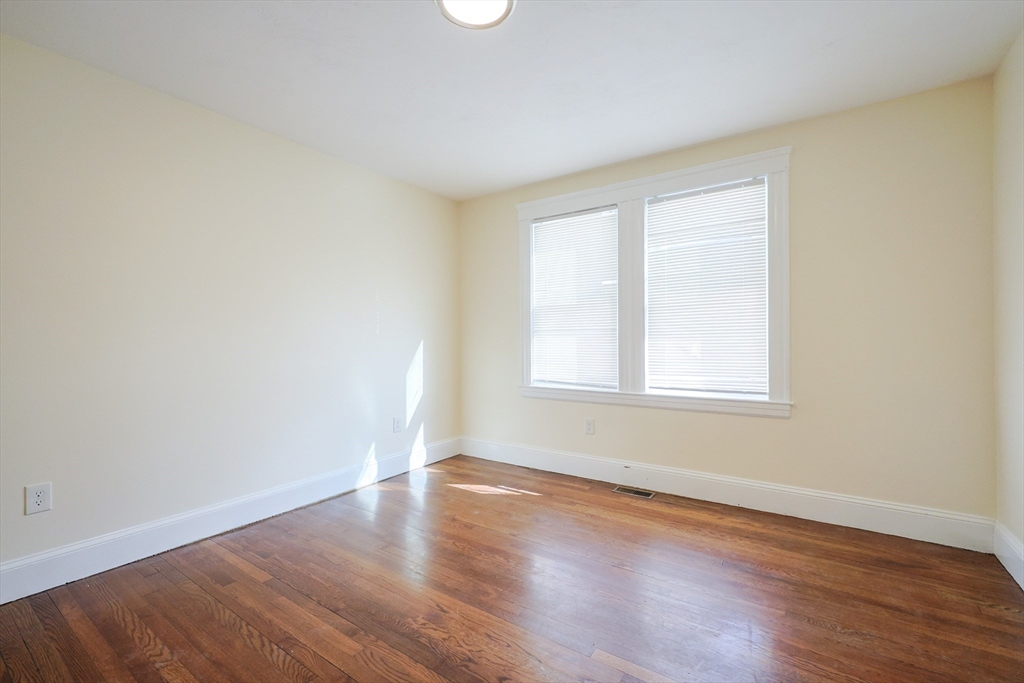 96 Mansfield Street Framingham, MA 01702 - Photo 9 of 39 an empty room with wooden floor and windows
