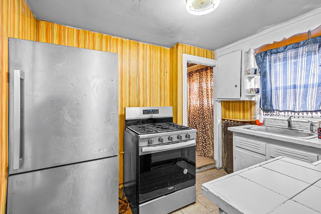 187 St Mary Street Needham, MA 02494 - Photo 11 of 28 a kitchen with a stove and a refrigerator