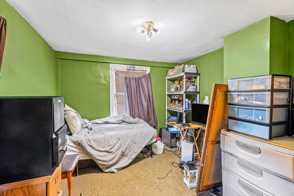 187 St Mary Street Needham, MA 02494 - Photo 23 of 28 a bedroom with a bed and a flat tv screen