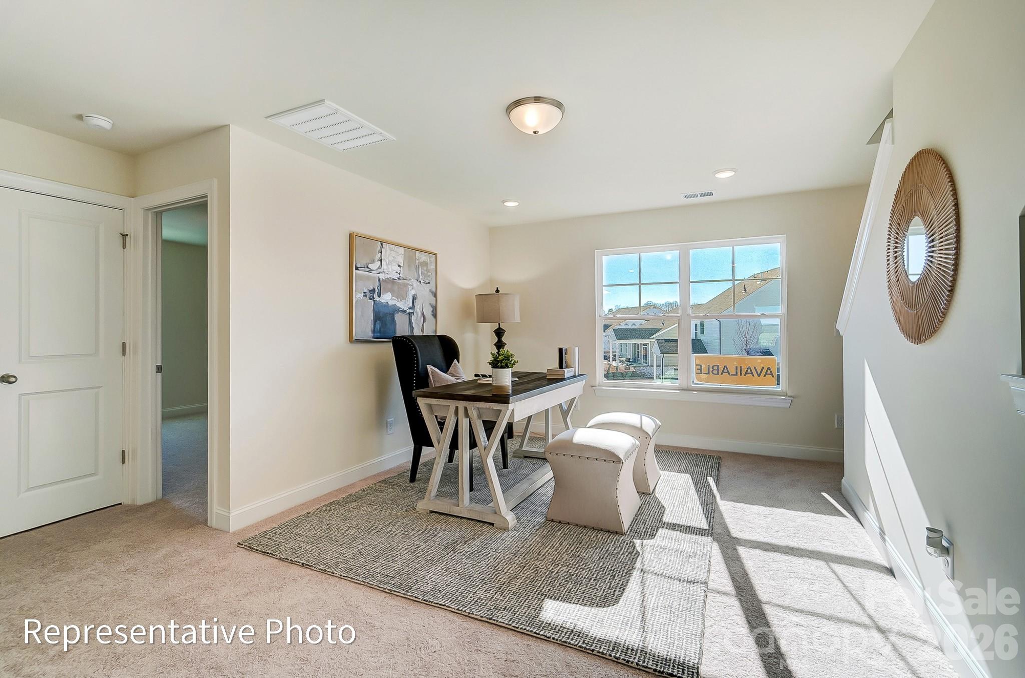 13127 Foxberry Road Charlotte, NC 28213 - Photo 13 of 24 a work room with furniture a rug and a window