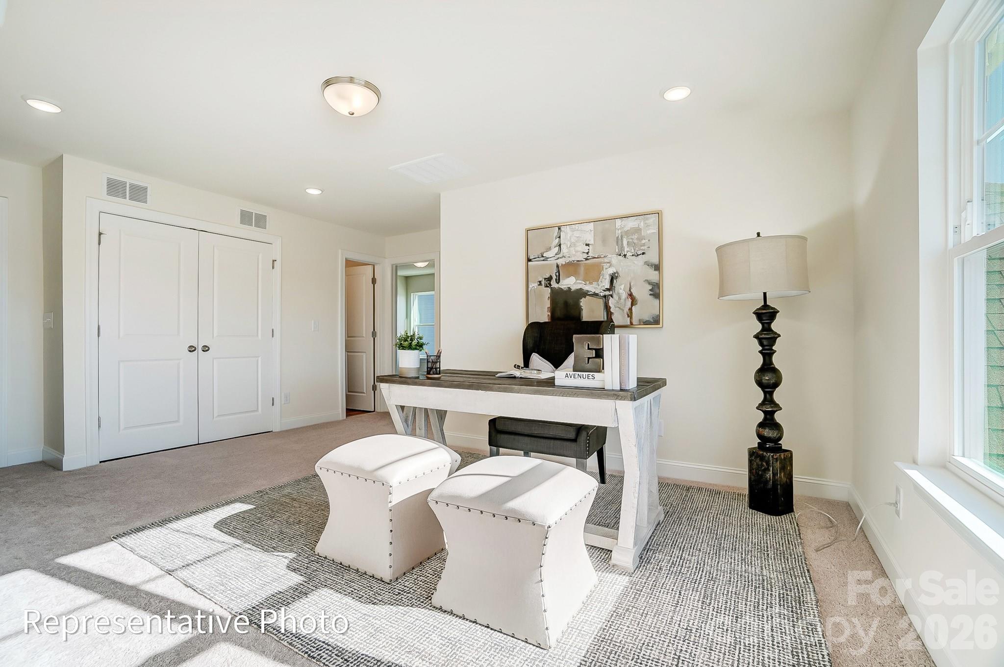 13127 Foxberry Road Charlotte, NC 28213 - Photo 14 of 24 a living room with furniture a rug and white walls