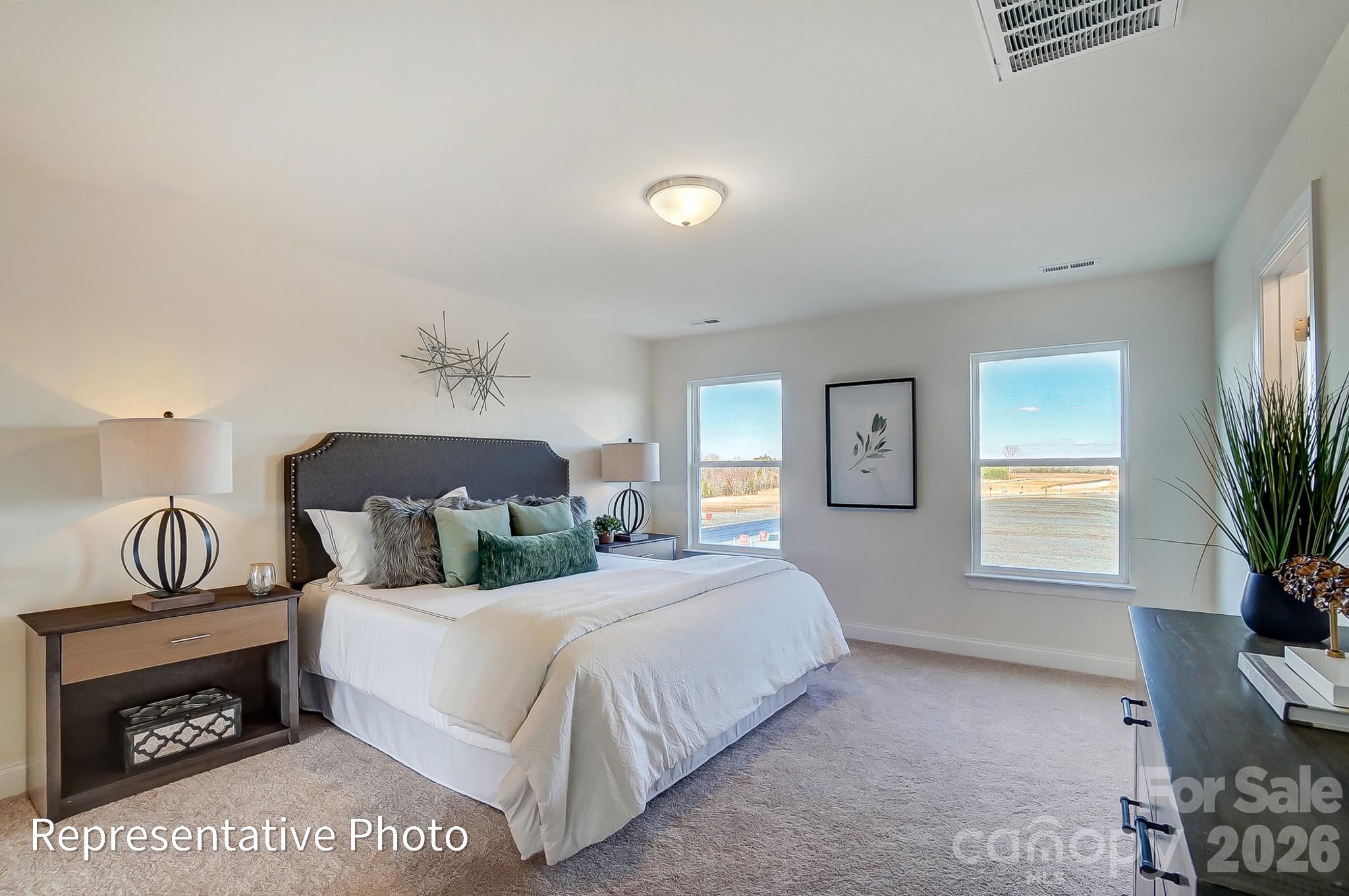 13127 Foxberry Road Charlotte, NC 28213 - Photo 15 of 24 a bedroom with a bed a mirror and a window