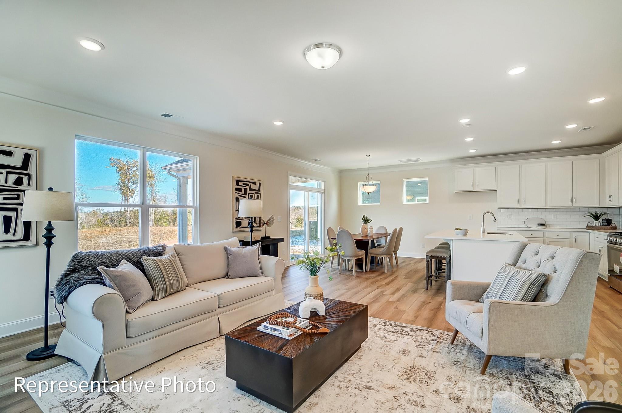 13127 Foxberry Road Charlotte, NC 28213 - Photo 5 of 24 a living room with furniture wooden floor and a large window