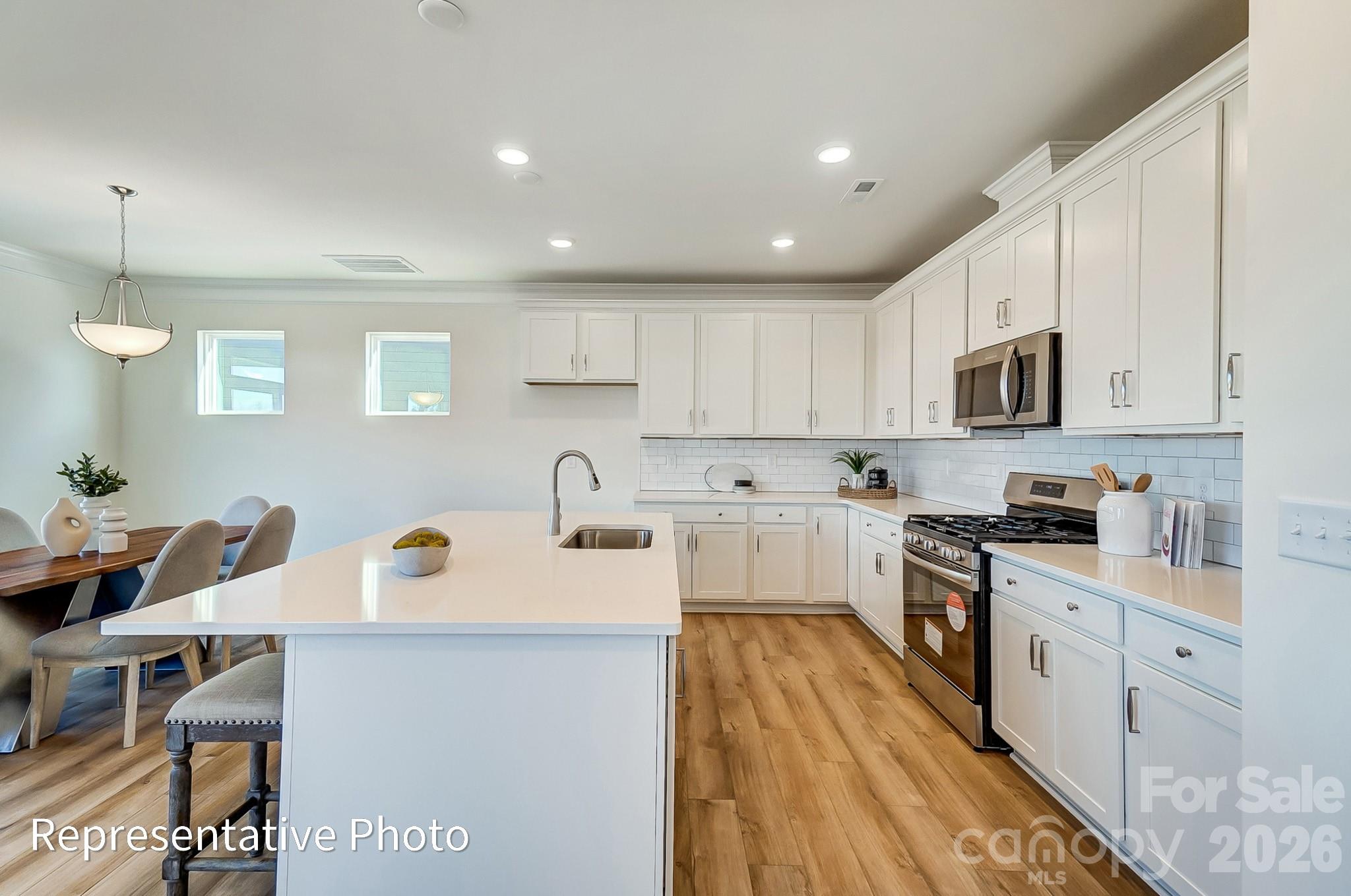13127 Foxberry Road Charlotte, NC 28213 - Photo 7 of 24 a kitchen with cabinets a sink and appliances