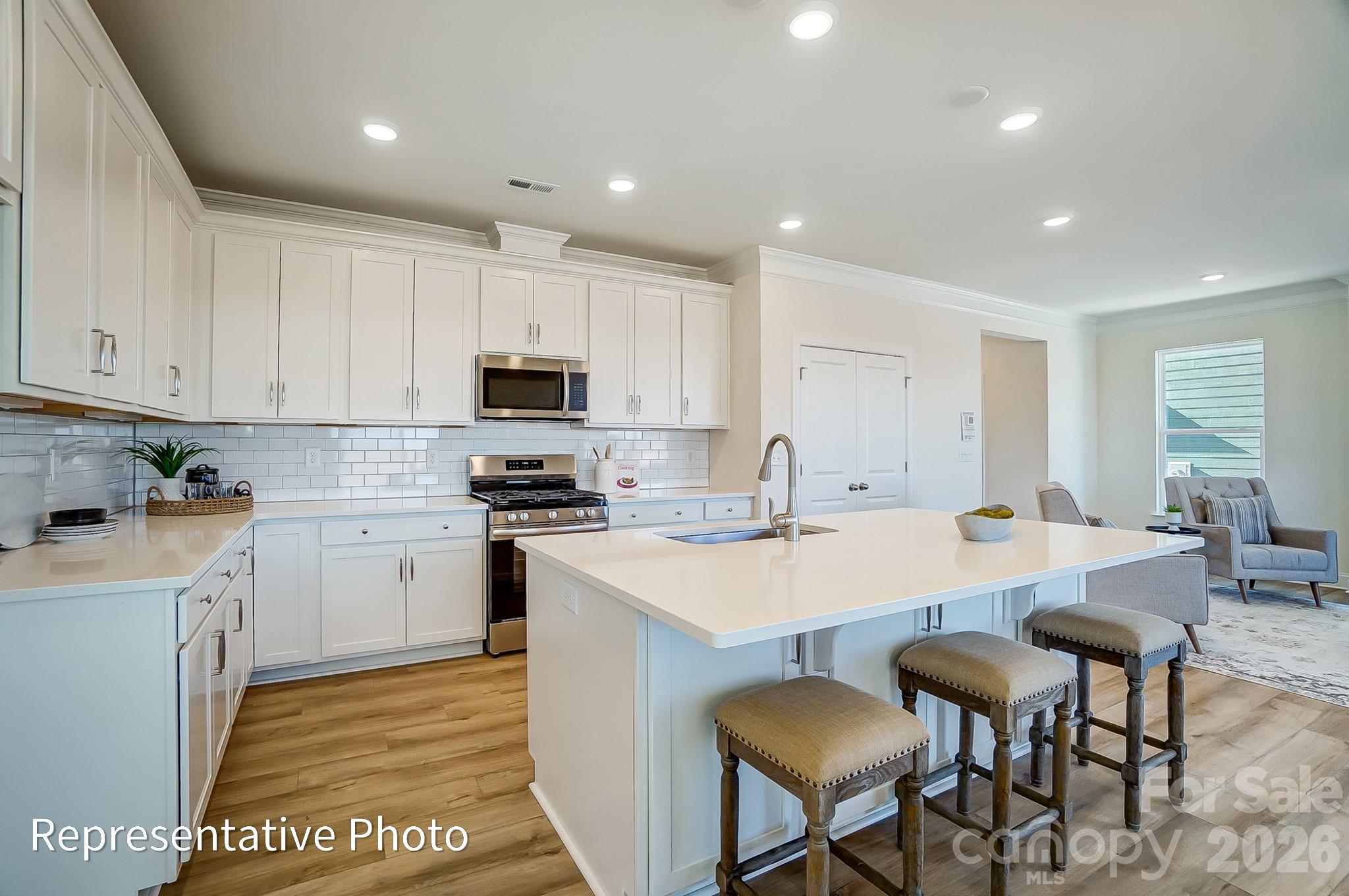 13127 Foxberry Road Charlotte, NC 28213 - Photo 10 of 24 a large kitchen with kitchen island a dining table and chairs