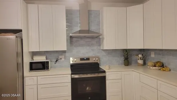 a kitchen with stainless steel appliances white cabinets and a stove