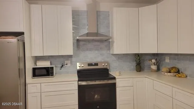 a kitchen with stainless steel appliances white cabinets and a stove