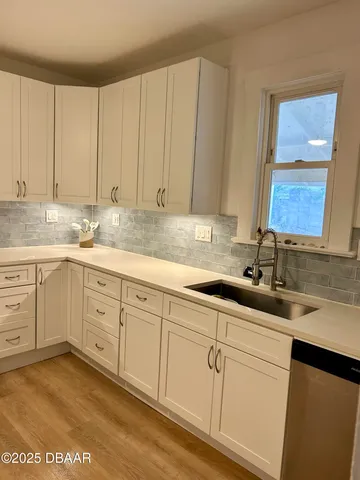 a kitchen with a sink cabinets and window