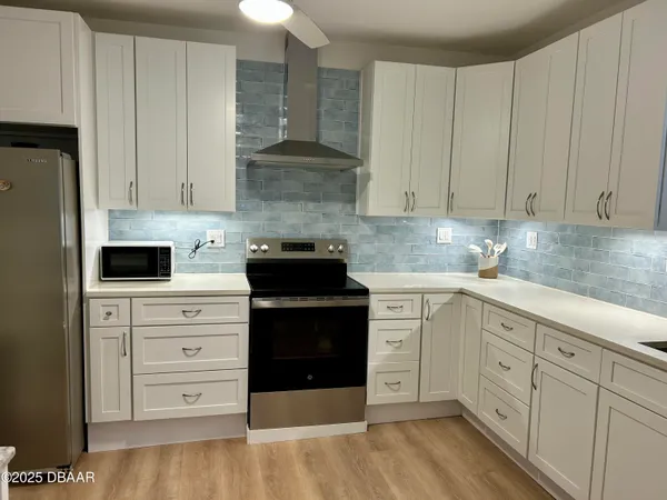 a kitchen with cabinets appliances and a counter space