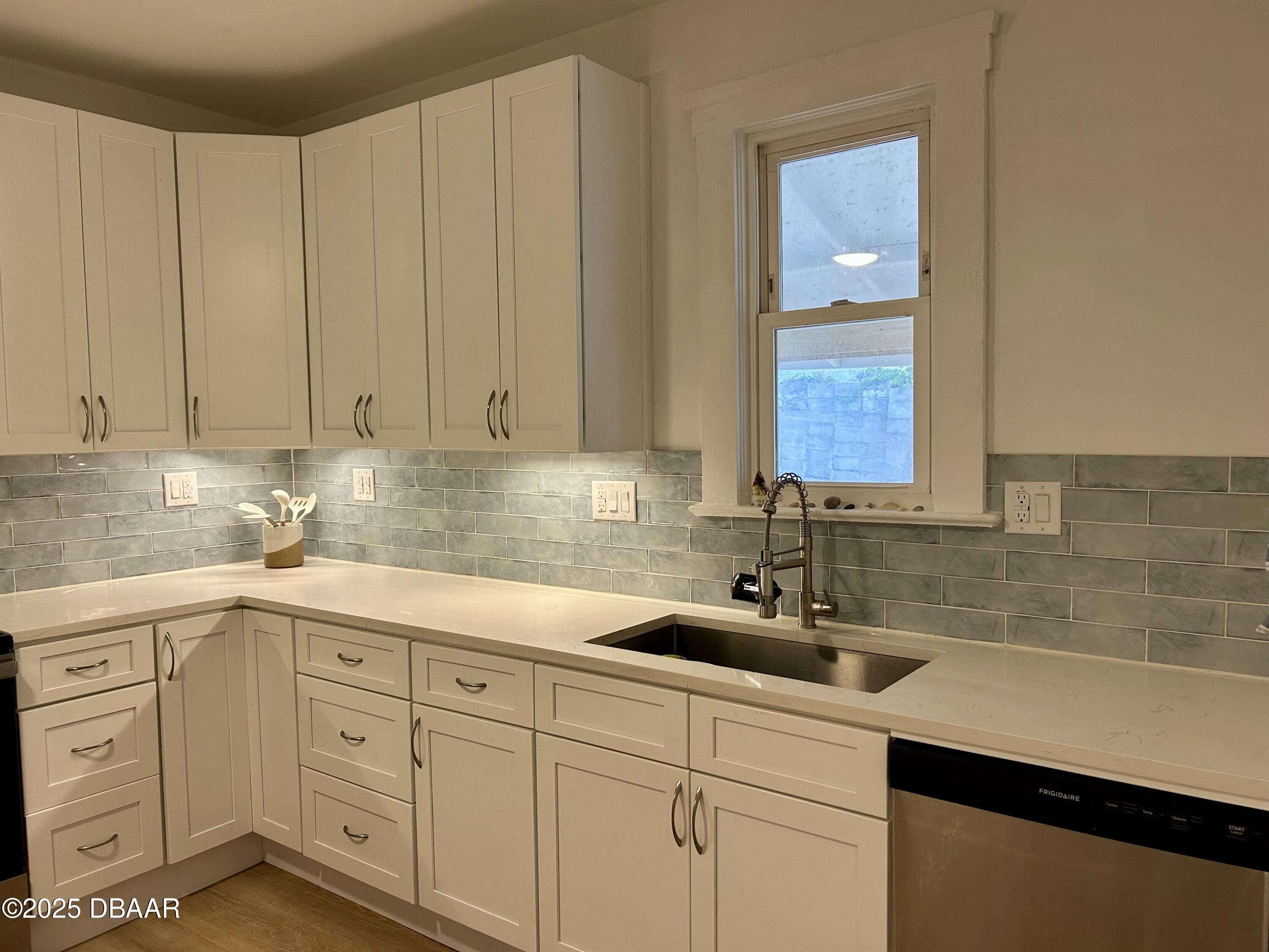 602 Temko Terrace Daytona Beach, FL 32118 - Photo 15 of 20 a kitchen with white cabinets and sink