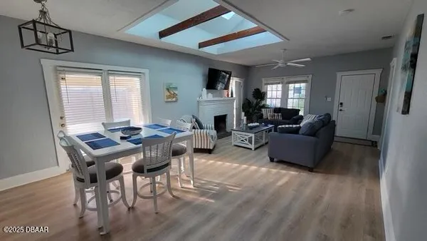 a view of a dining room with furniture window and wooden floor