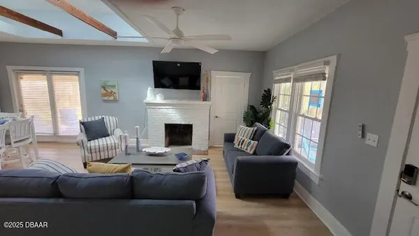a living room with furniture a fireplace and a flat screen tv