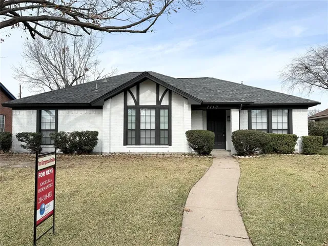 a front view of a house with a yard outdoor seating and garage