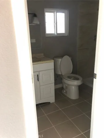 a bathroom with a toilet a sink and a window