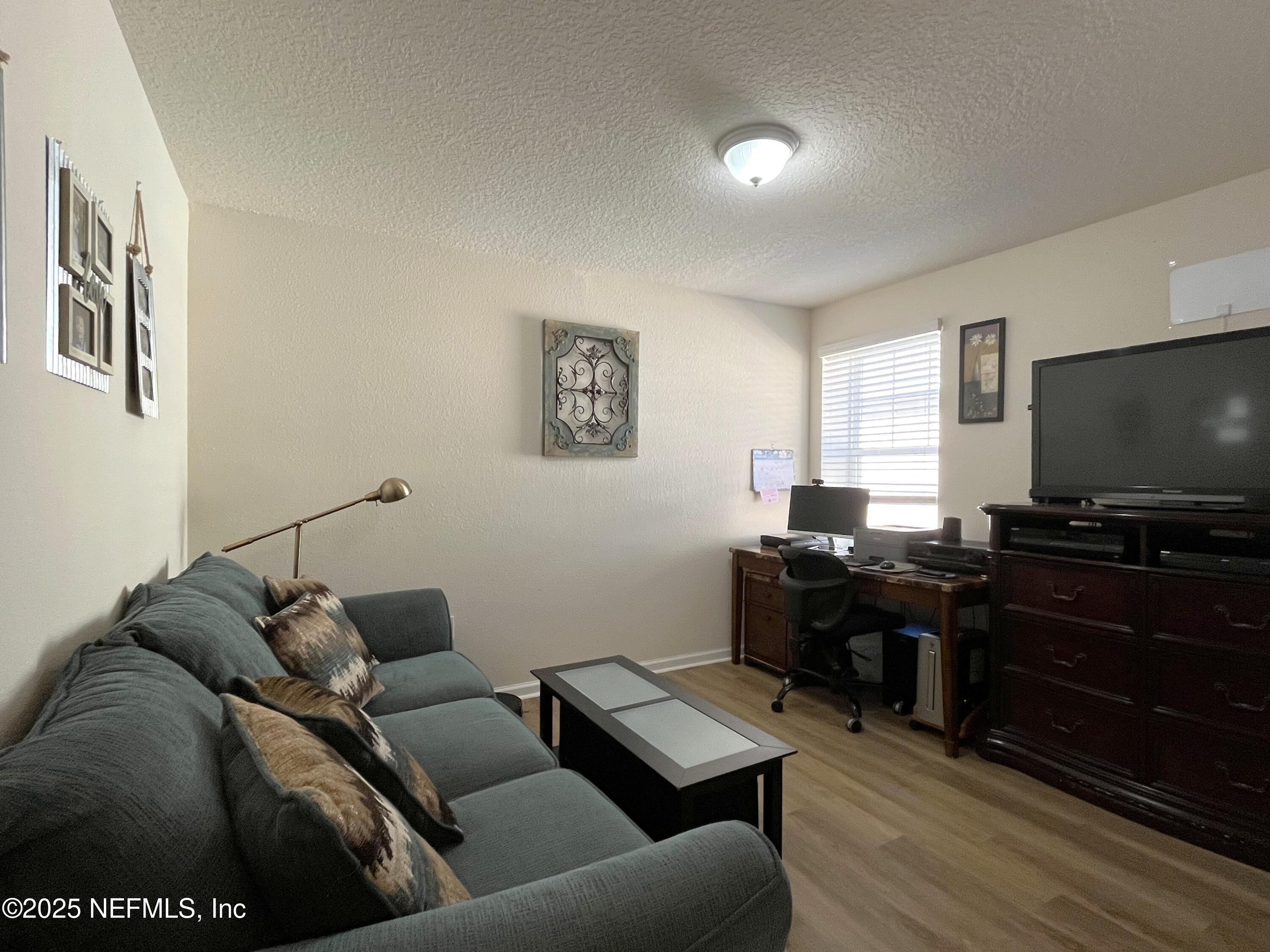 2103 Golden Lake Loop, Unit 2103 St. Augustine, FL 32084 - Photo 12 of 32 a living room with furniture and a flat screen tv
