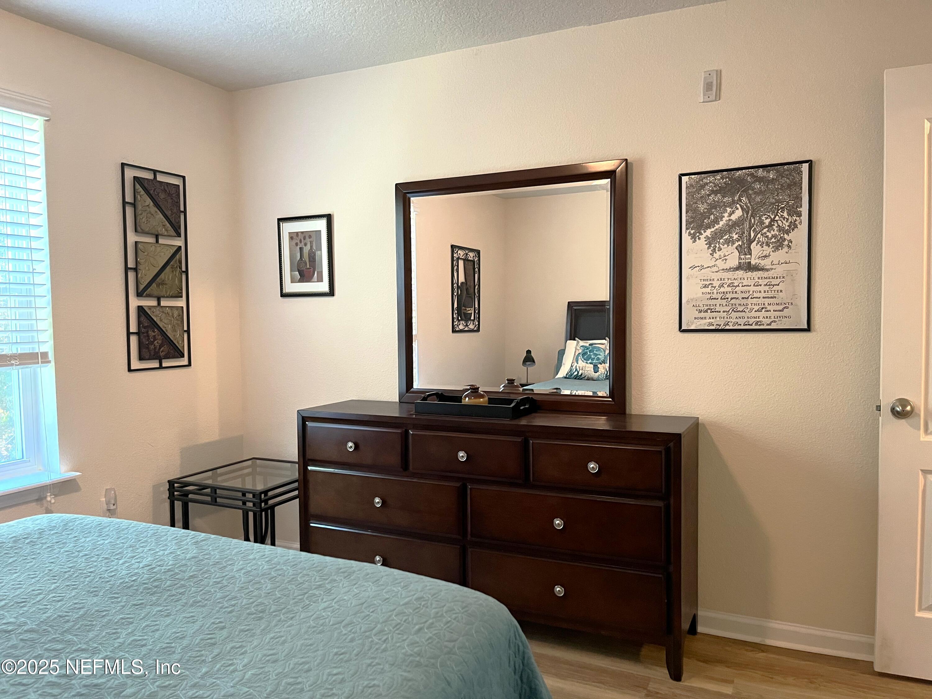 2103 Golden Lake Loop, Unit 2103 St. Augustine, FL 32084 - Photo 16 of 32 a room with a dresser and a mirror