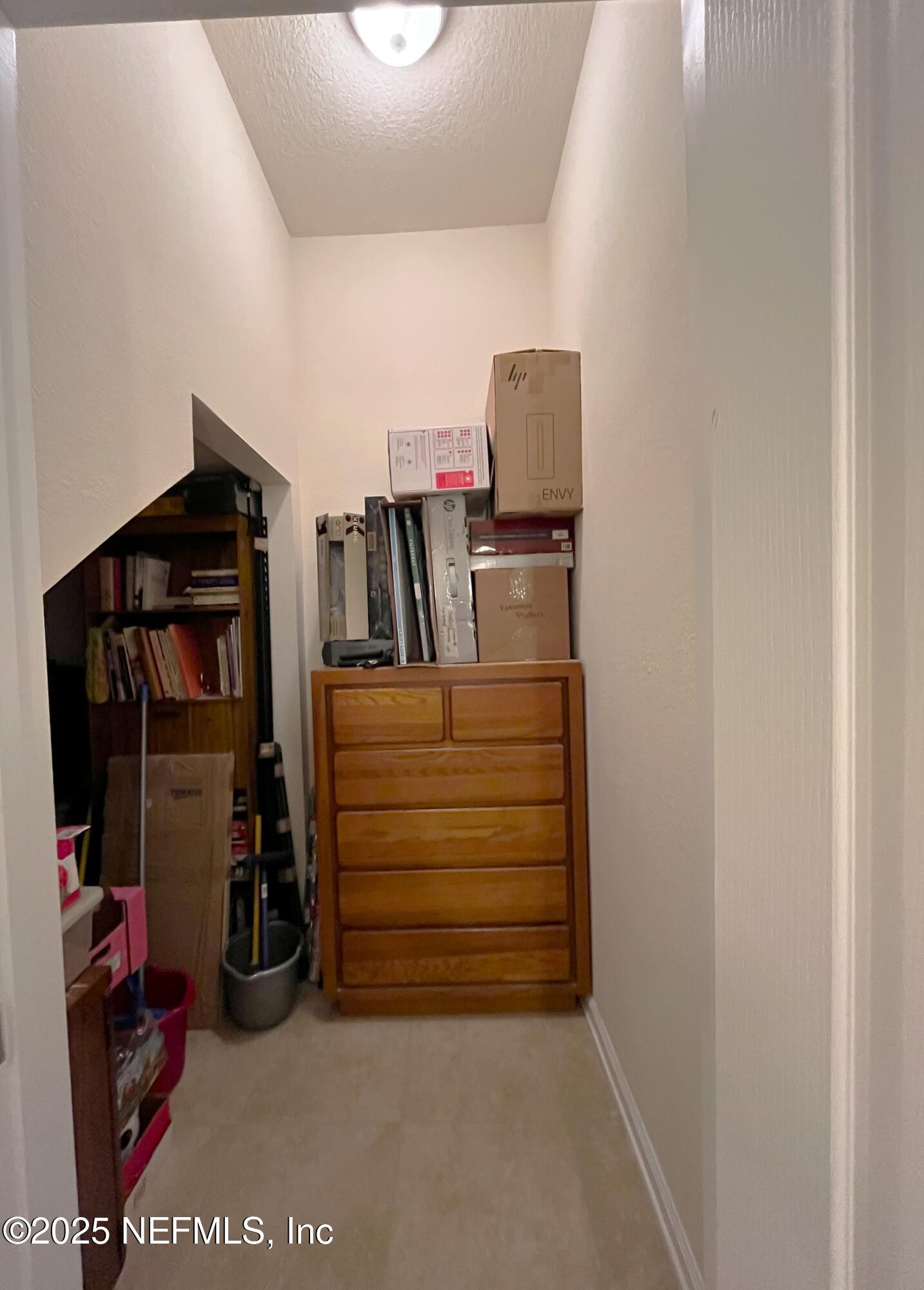 2103 Golden Lake Loop, Unit 2103 St. Augustine, FL 32084 - Photo 22 of 32 a view of walk in closet with clothes and shoes