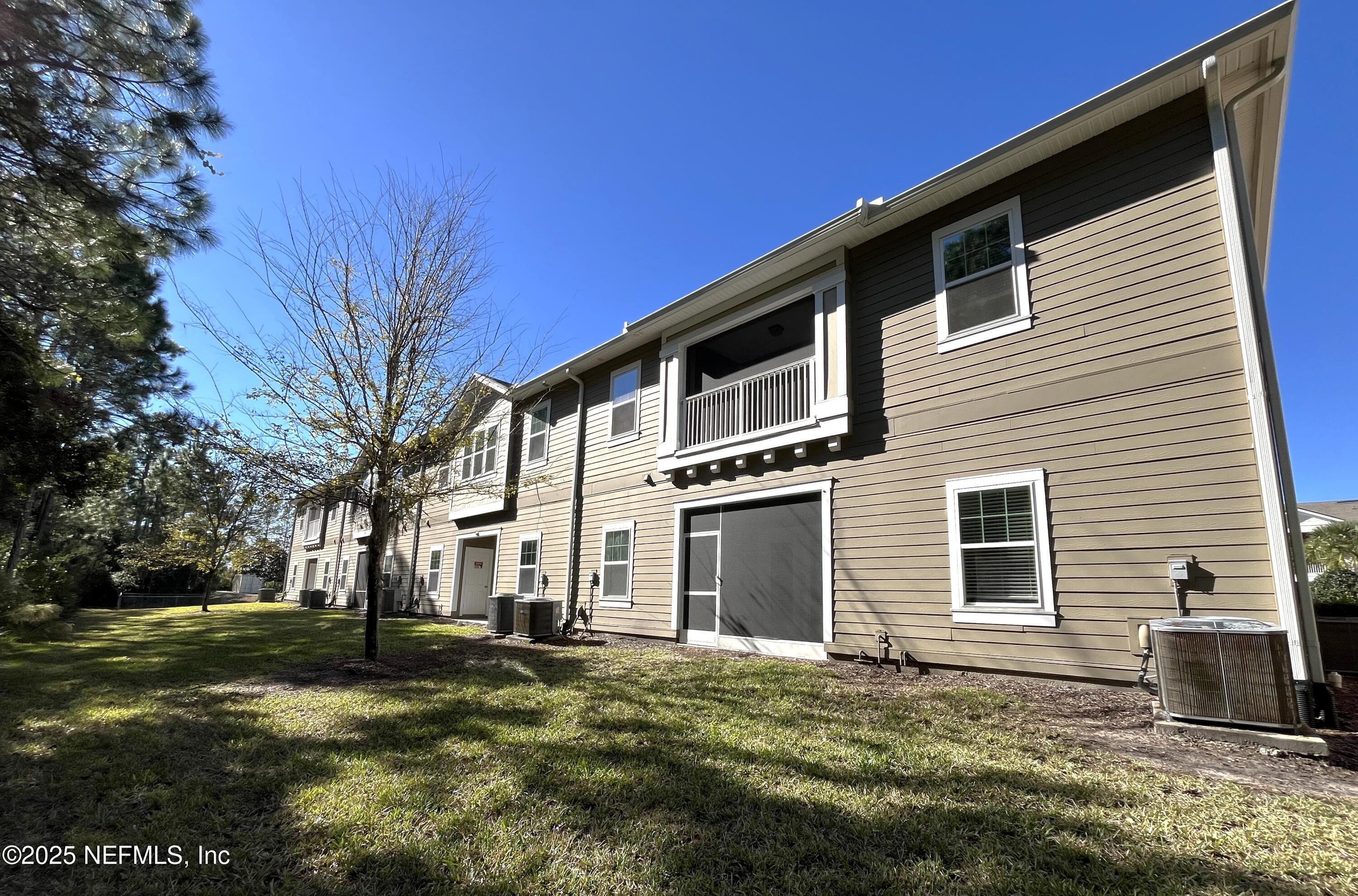 2103 Golden Lake Loop, Unit 2103 St. Augustine, FL 32084 - Photo 26 of 32 a front view of a house with a yard