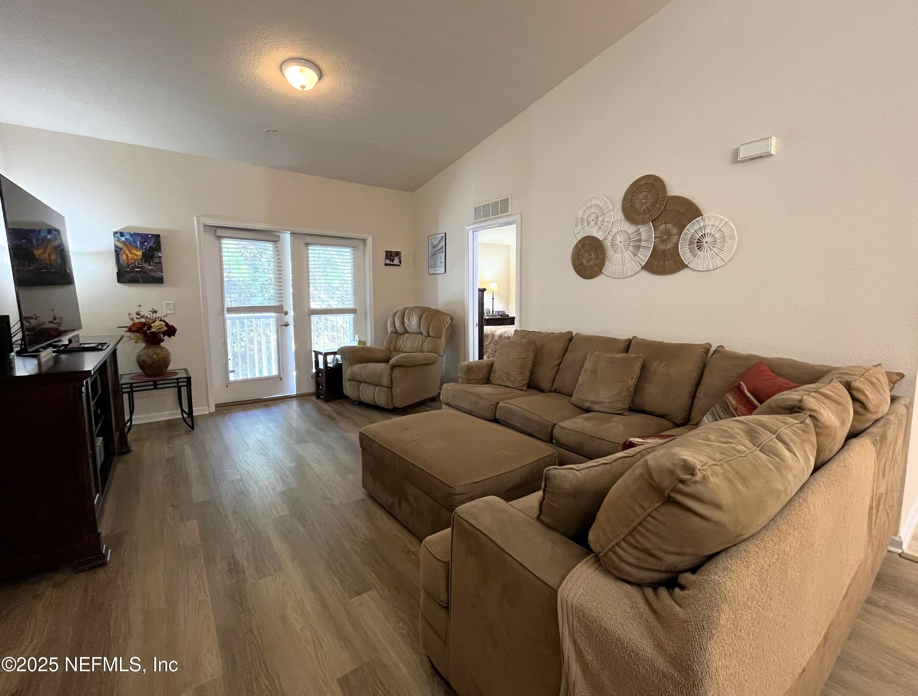2103 Golden Lake Loop, Unit 2103 St. Augustine, FL 32084 - Photo 7 of 32 a living room with furniture and a flat screen tv